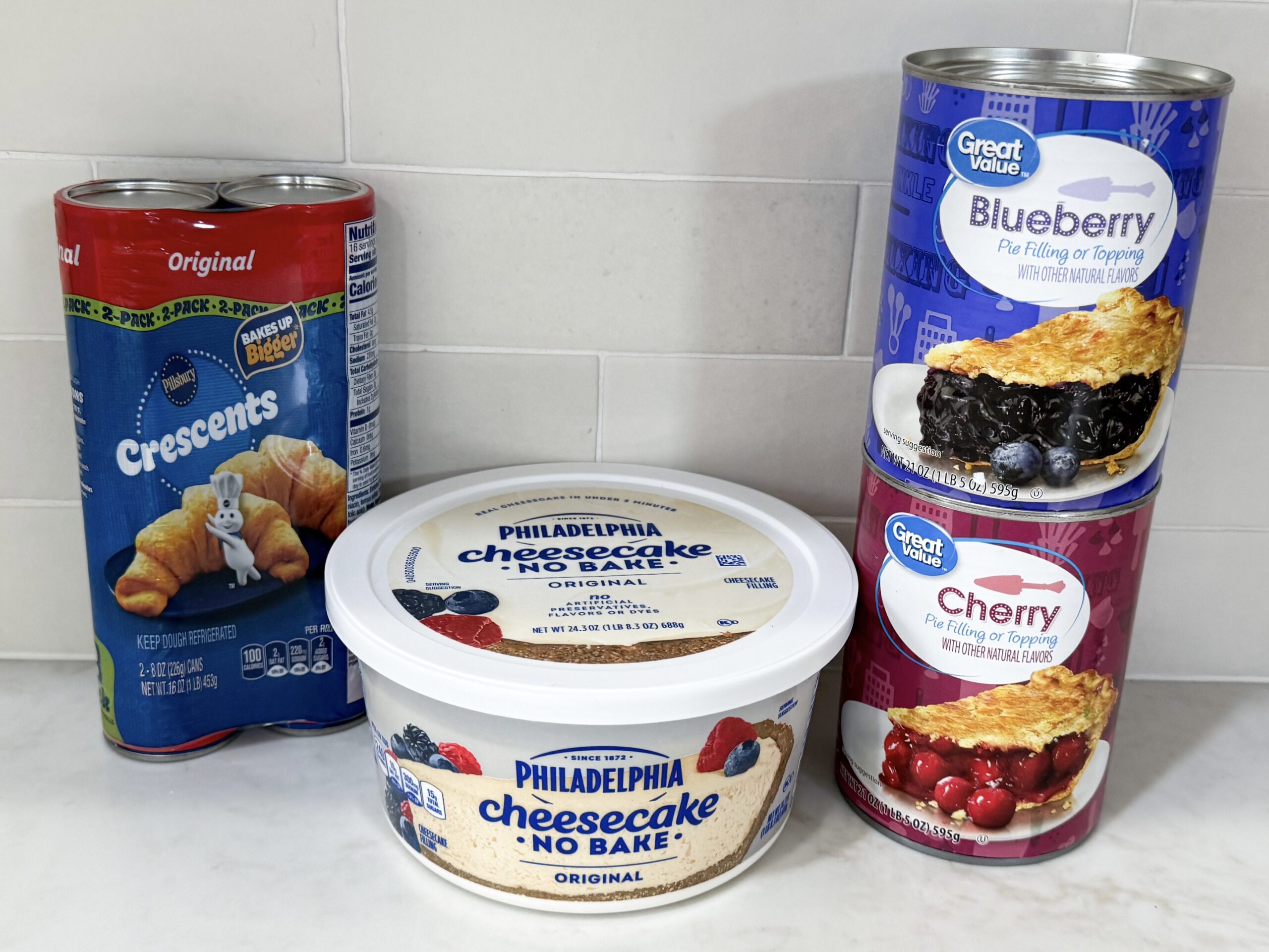 Ingredients for mini cheesecake pies on counter