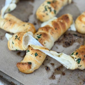 Mozzarella-stuffed garlic breadsticks baked golden brown