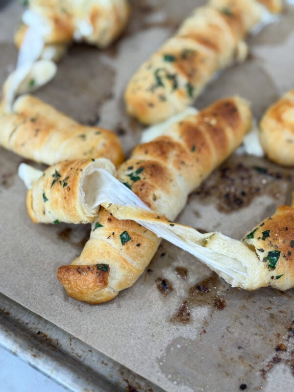 Mozzarella-stuffed garlic breadsticks baked golden brown