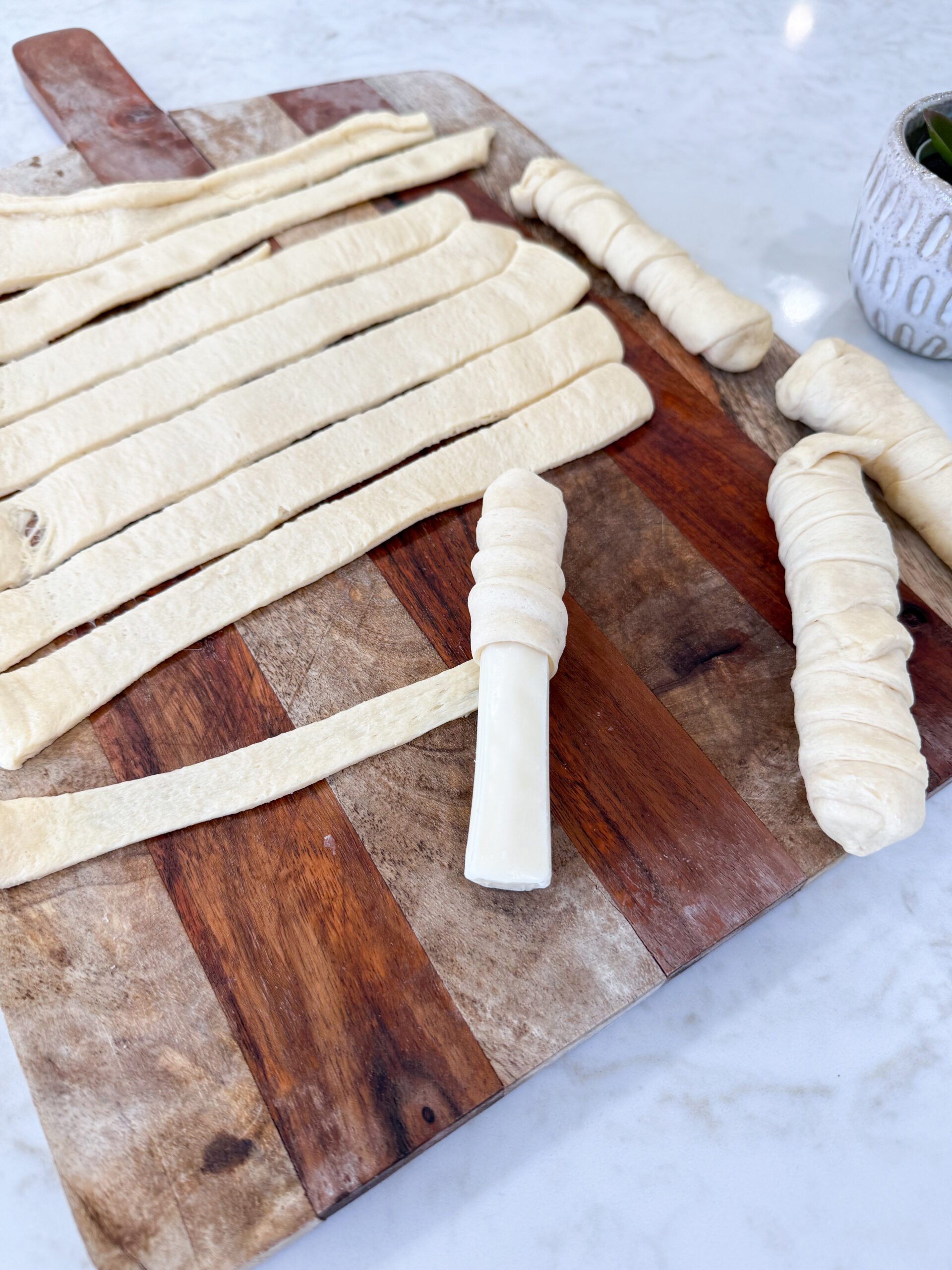 Unrolled crescent dough cut into 9 thin strips