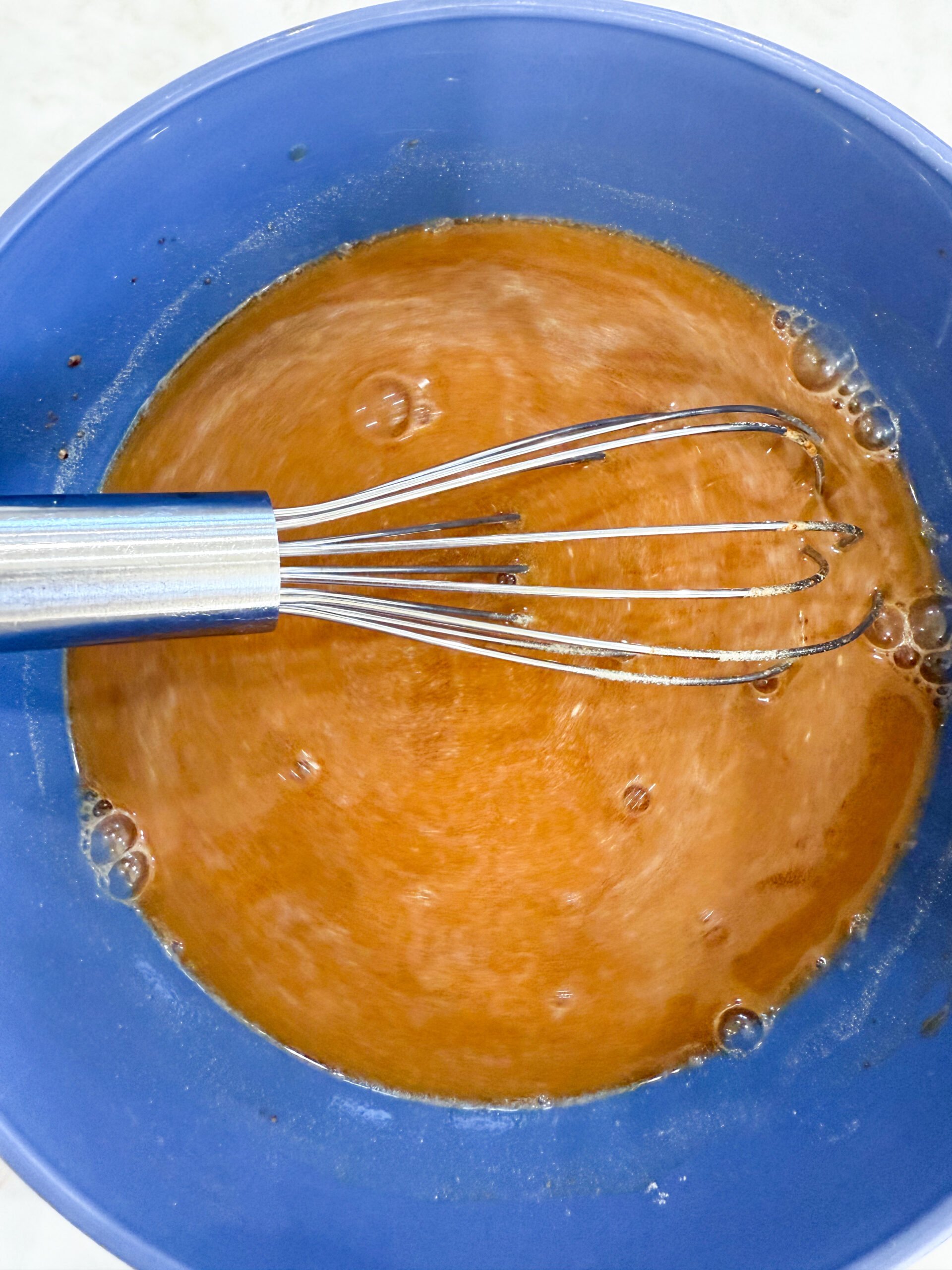 Beef broth, Worcestershire, garlic, and gravy mix in a bowl.