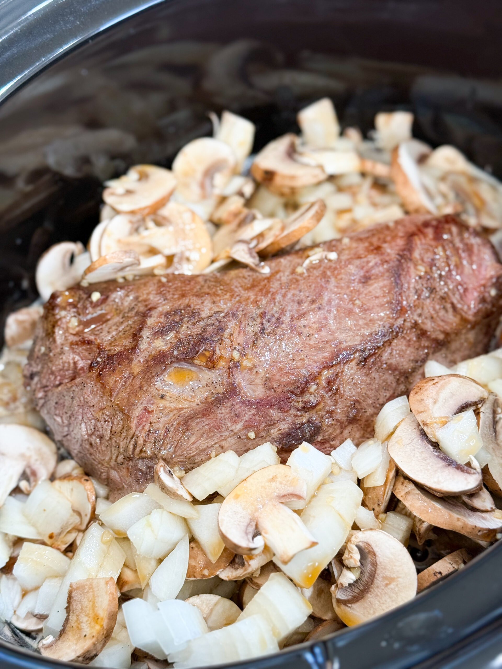 Beef, mushrooms, and onions in slow cooker