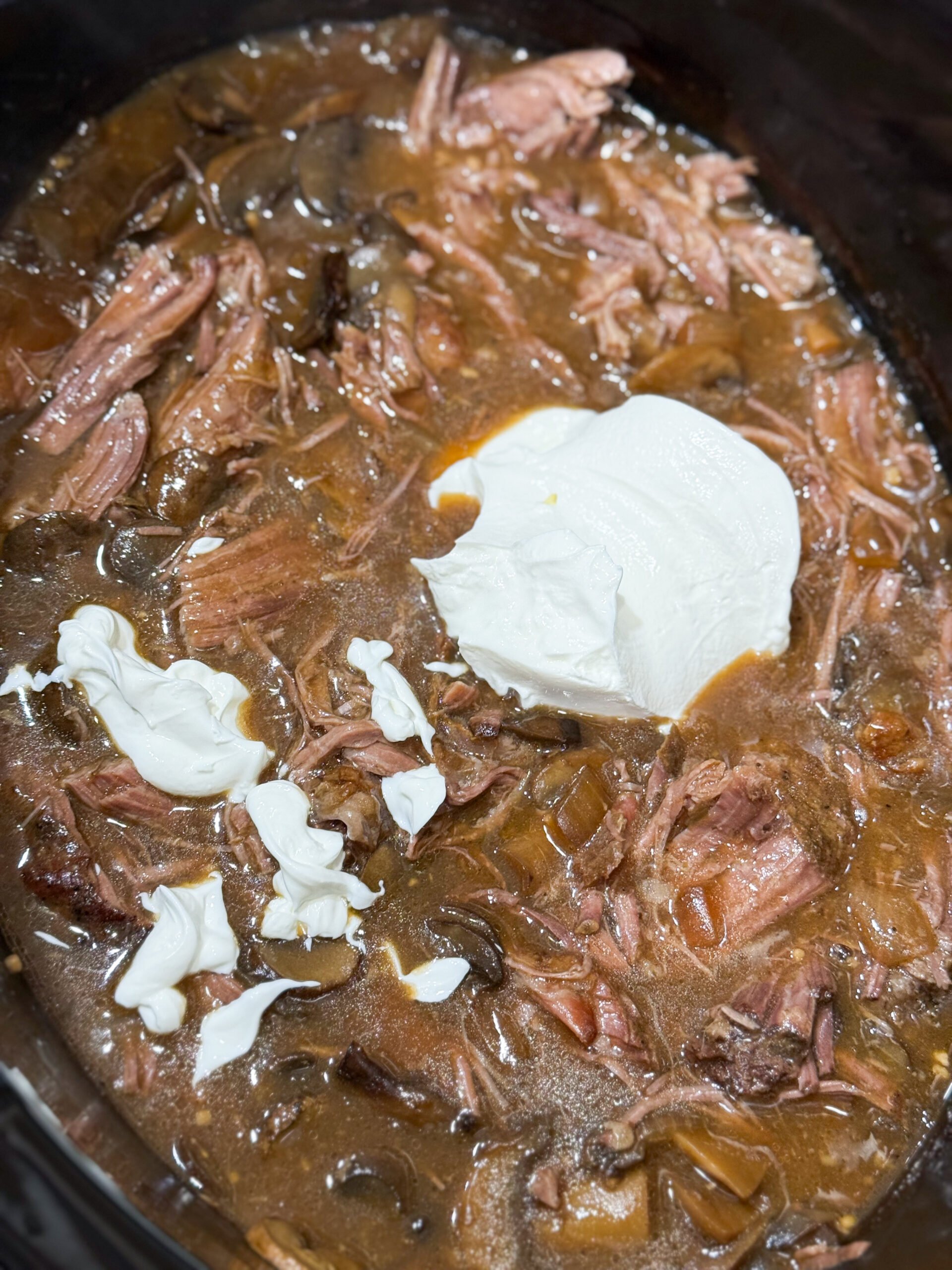 Sour cream added to beef stroganoff slow cooker