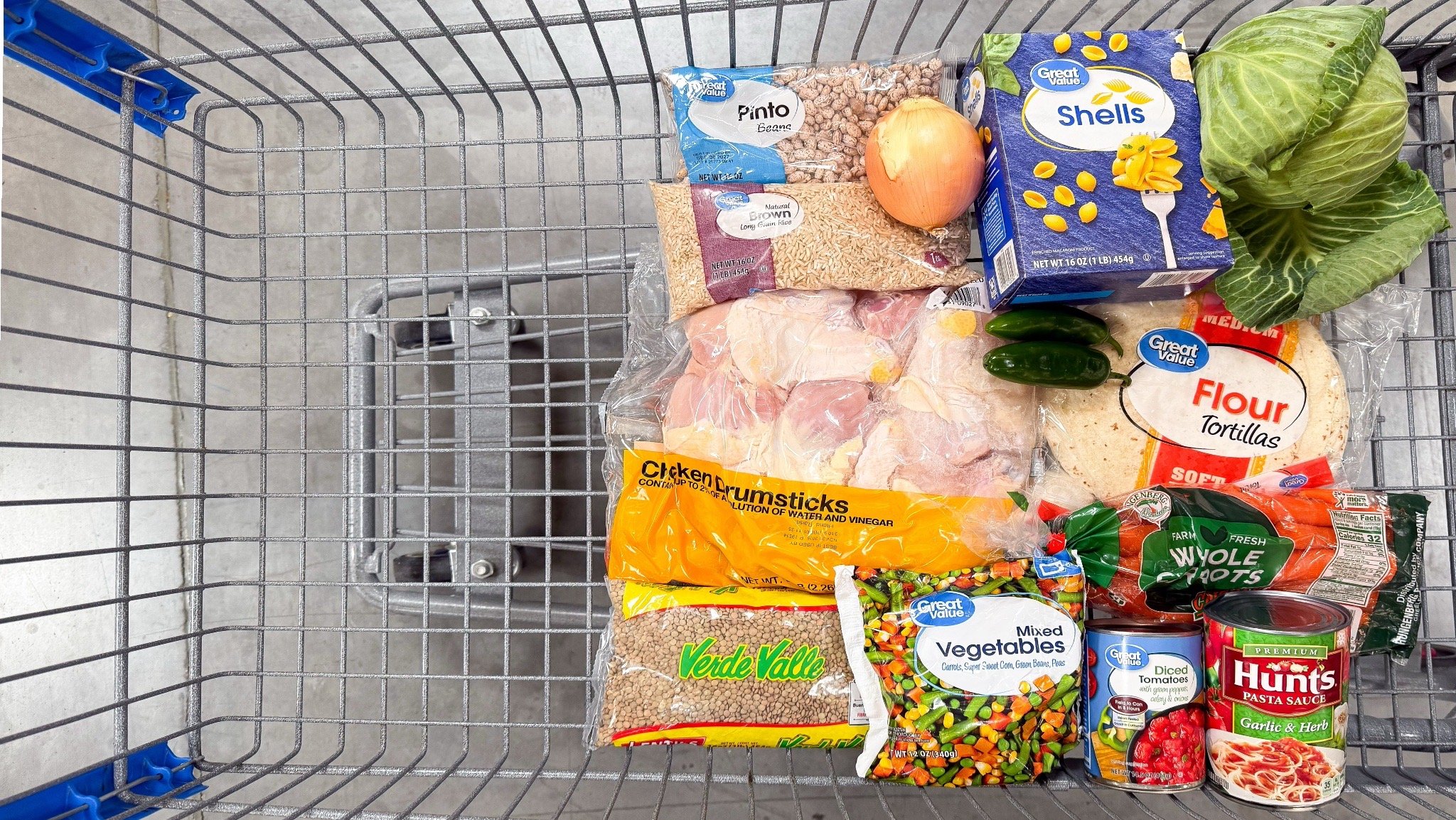 Groceries for Eight budget friendly family meals made with $20 of Walmart ingredients sitting in a shopping cart at walmart
