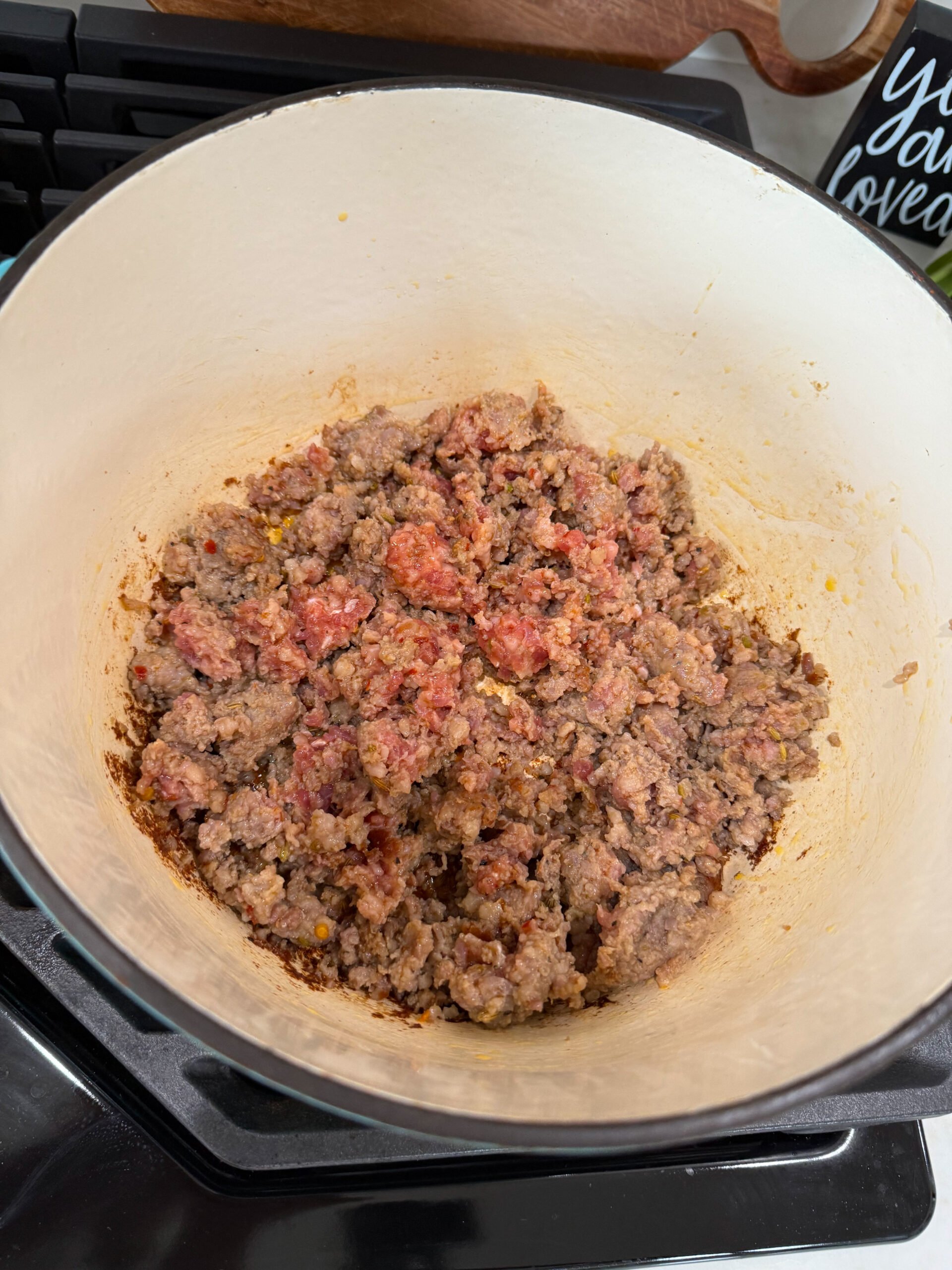 browning sausage in a pot