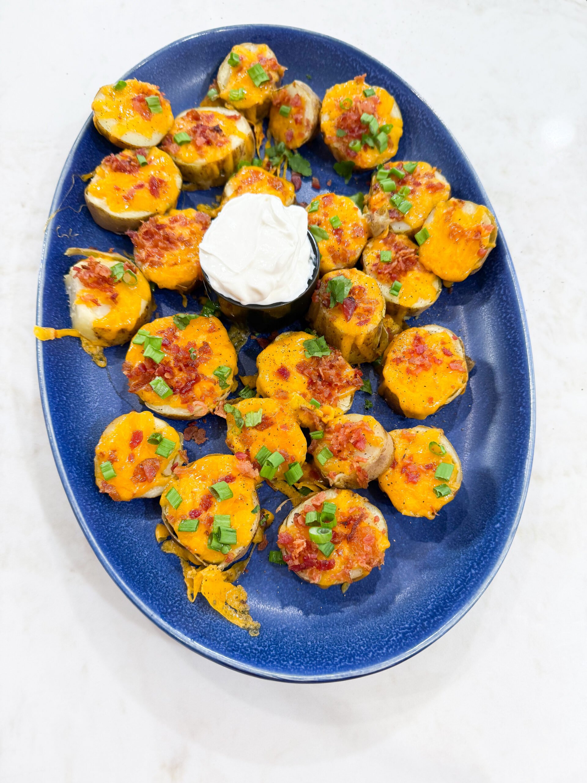 Loaded potato rounds served on a plate