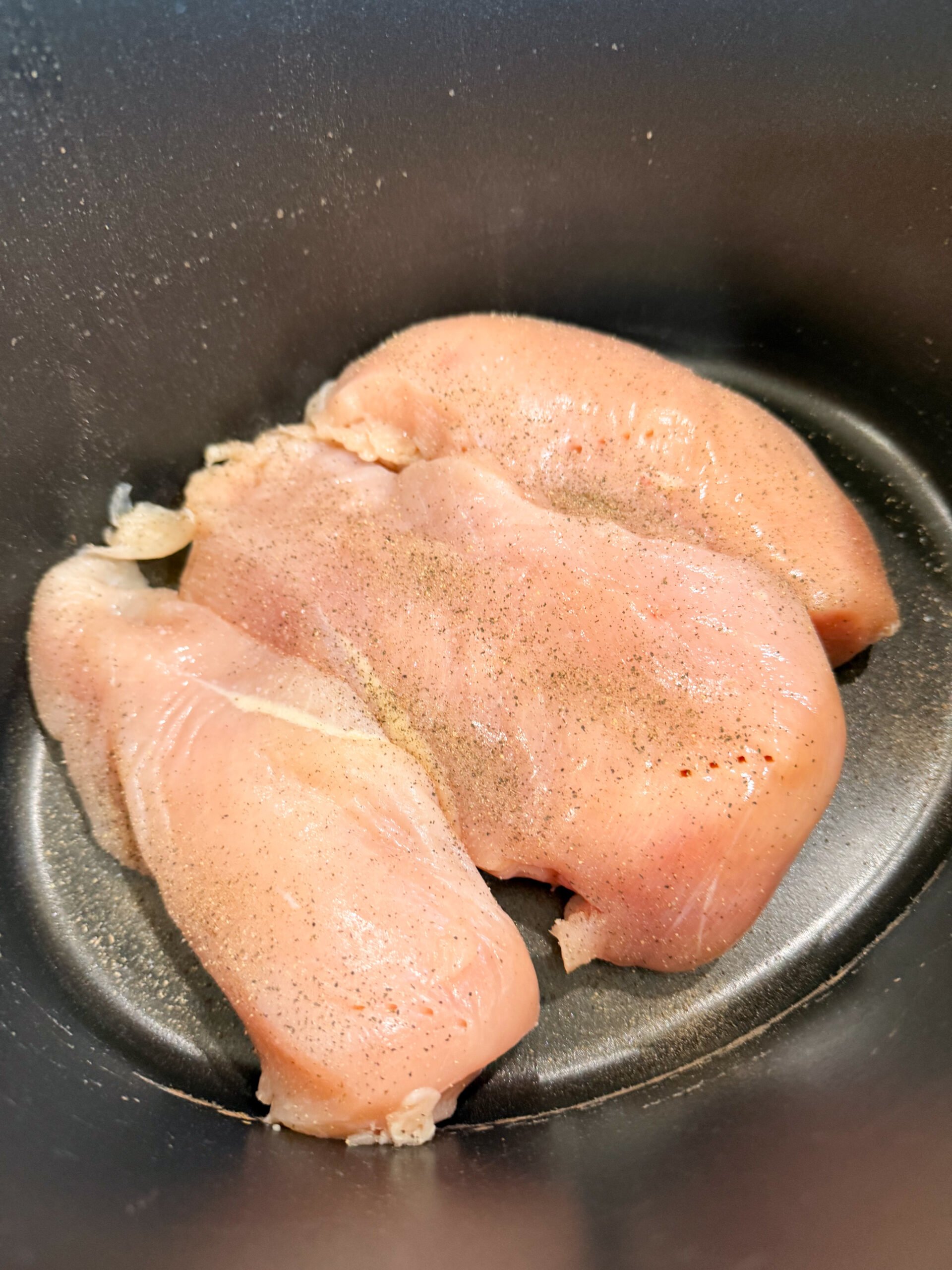 chicken breasts placed in slow cooker