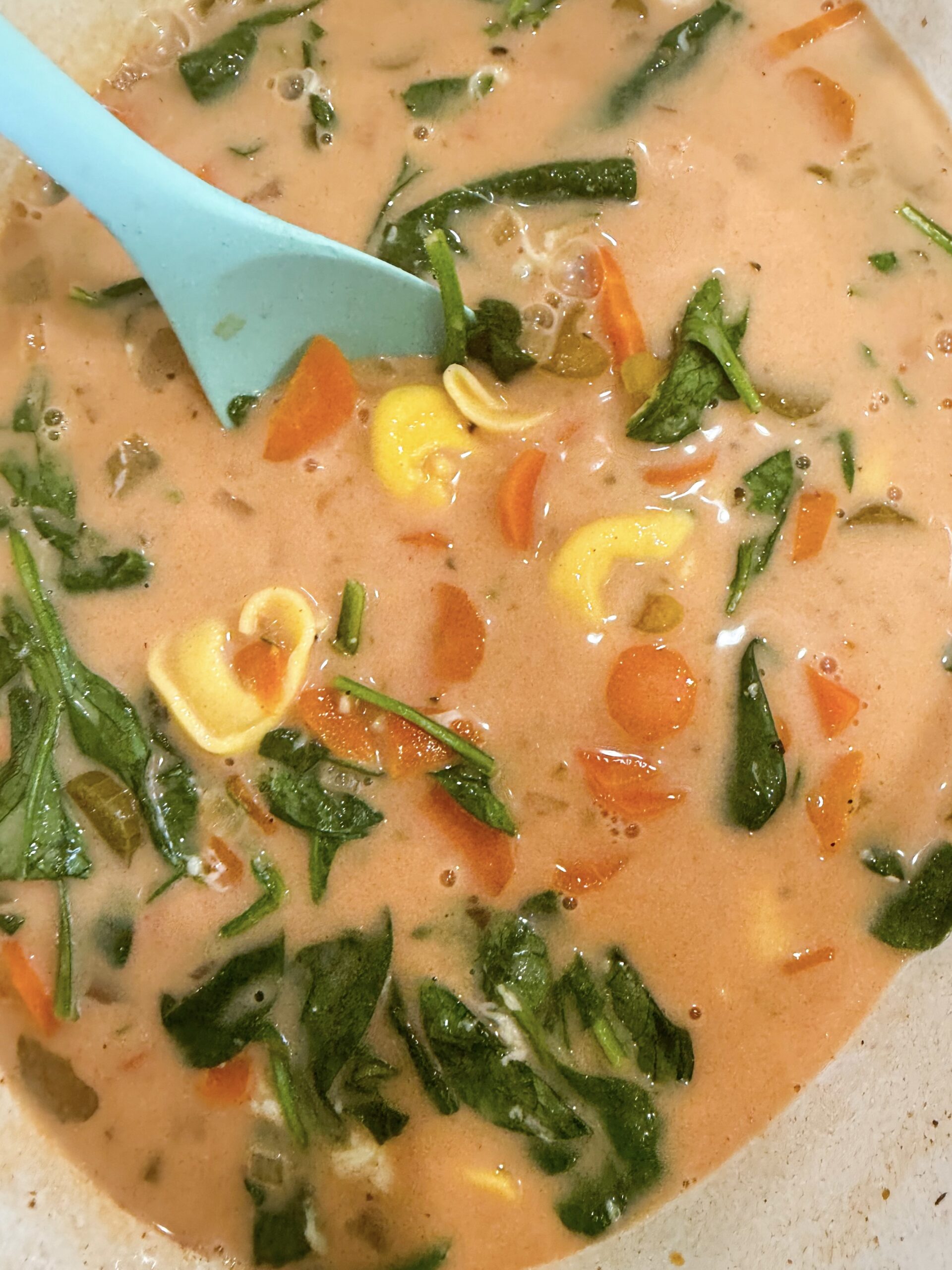 tortellini and cream added to the soup and stirred