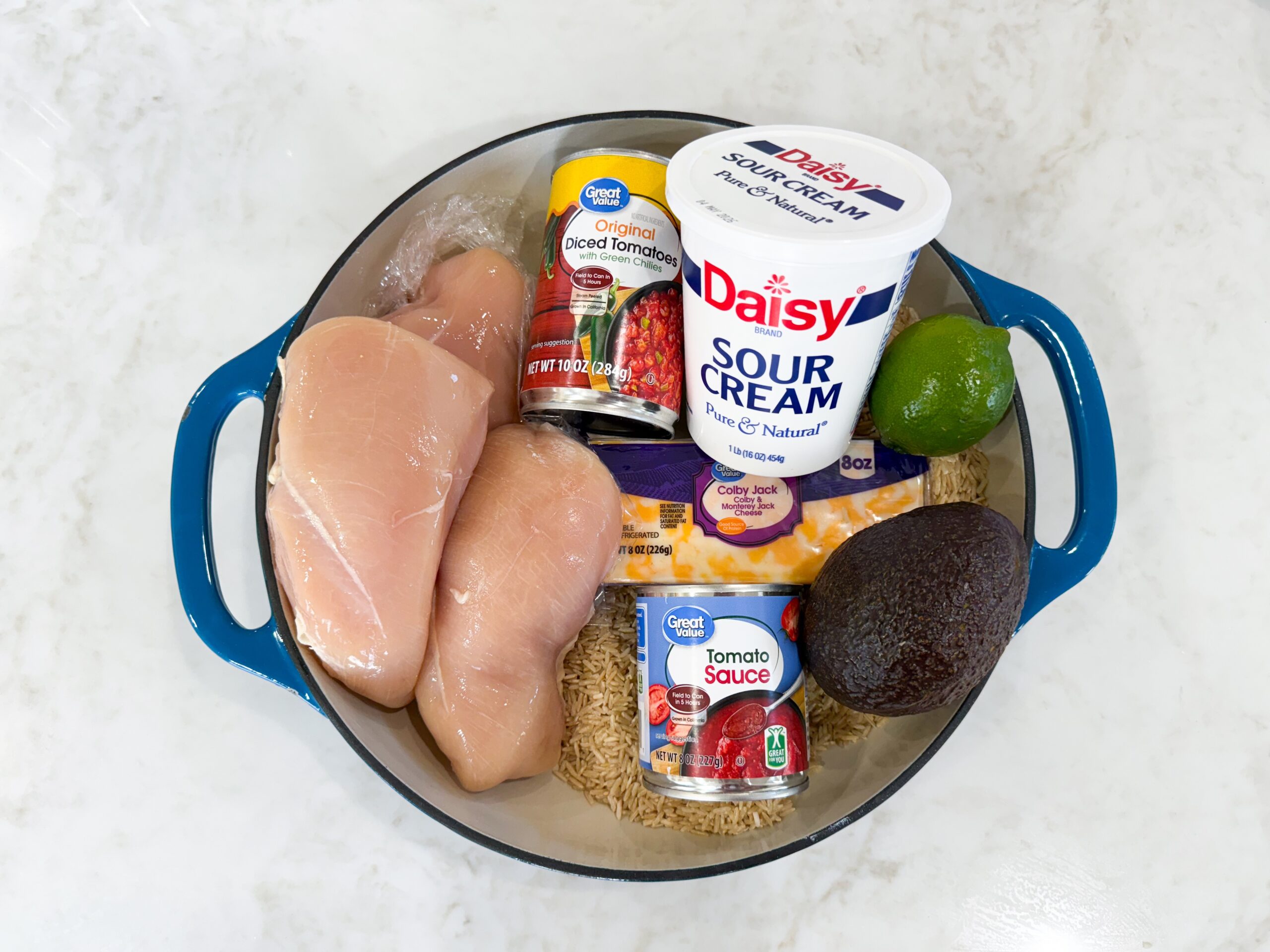 Ingredients for chicken taco rice in a skillet