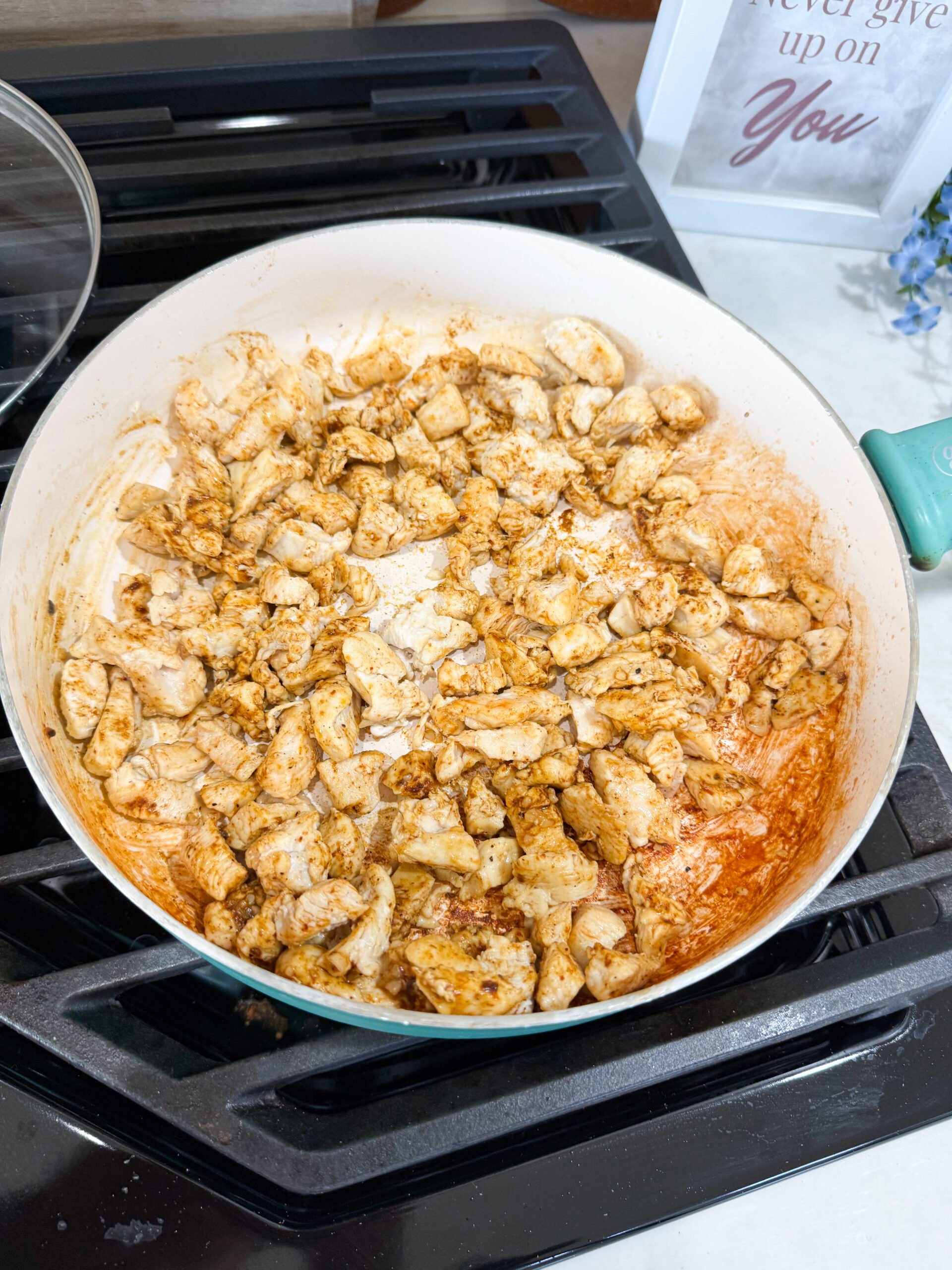 spices added to the cooked chicken in the skillet