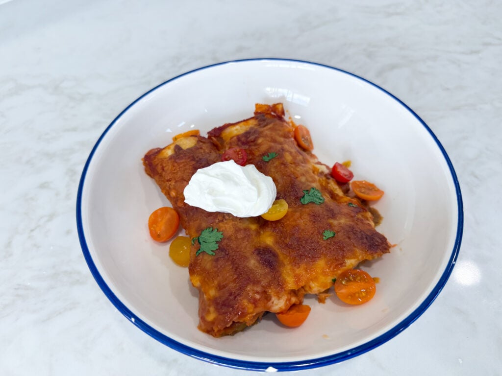 Smothered beef and bean burritos baked with red enchilada sauce and cheese